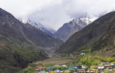 panorama of beautiful valley surrounded by snowcapped himalaya mountains, birds eye view of...