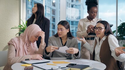 Overworked stressed multiethnic women females team African American Japanese Muslim hijab Arabian...