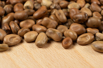 Whole dried raw uncooked vicia faba beans close-up