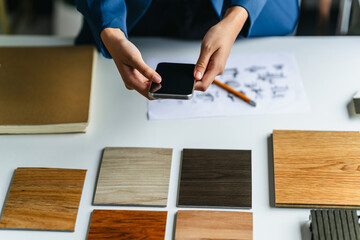 Interior designer discussing wood laminate materials in modern office