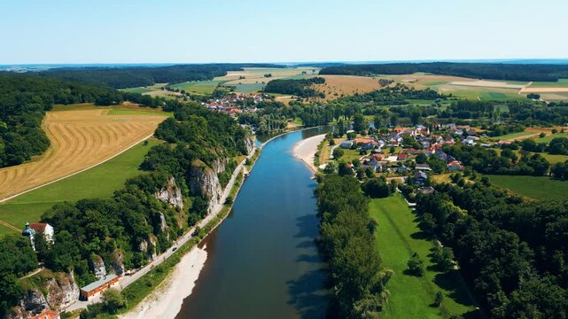 Kloster Weltenburg on the Danube River, Germany, shot from a drone in summer. Historic Benedictine monastery surrounded by forested cliffs and dramatic river curves near Kelheim