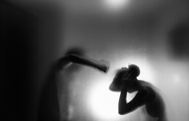 Men hitting women behind the frosted glas