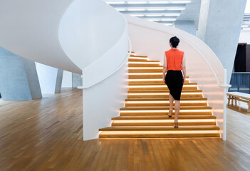 Woman walking on the spiral staircase