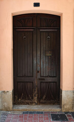An Elegant Brown Wooden Door Set in a Charming and Picturesque Urban Environment