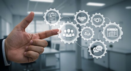 Fototapeta premium A hand pointing towards interconnected gears illustrating business processes and workflow.