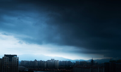 City buildings under the storm clouds