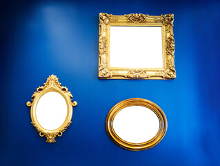 Golden picture frames on blue wall