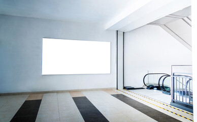 Blank billboard next to the escalator