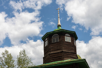 A beautiful orthodox church with a cross against a vibrant blue sky and clouds. The Decembrist...