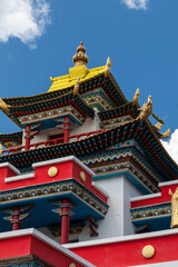 Obraz premium Vibrant colors adorn a traditional Tibetan temple under a brilliant blue sky, creating a visually stunning scene. Datsan in Chita, Russia on June 29, 2025