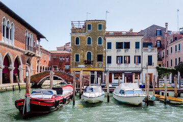 Fototapeta premium Venetian Canal with Boats and Historic Buildings in Venice