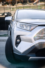 New, stylish car parked in a city parking lot. Concept of leasing and buying a new car.