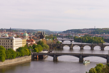 Fototapeta premium Panoramic view of Prague with Vltava River and historic bridges