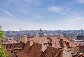 Scenic panoramic view over Prague city with red rooftops and historic landmarks