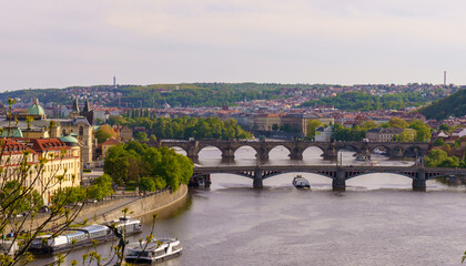 Naklejka premium Panoramic view of Prague with Vltava River and historic bridges