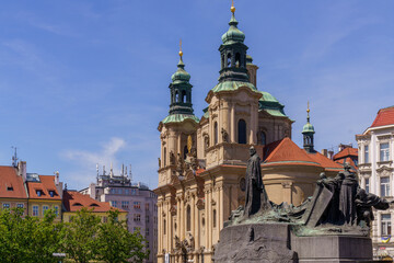 Fototapeta premium St. Nicholas Church and Jan Hus monument in Old Town Square, Prague