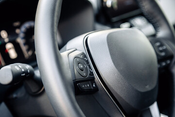 Close-up of a car steering wheel in a modern new car. The interior of a stylish new car. Concept of...