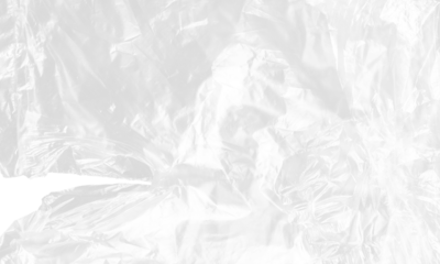 plastic transparent cellophane bag on white background. The texture looks blank and shiny. The plastic surface is wrinkly and tattered making abstract pattern