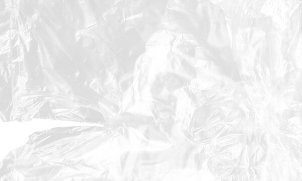 plastic transparent cellophane bag on white background. The texture looks blank and shiny. The plastic surface is wrinkly and tattered making abstract pattern