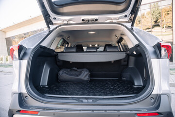 Gray modern car with open empty trunk. Travel or rent modern car concept.