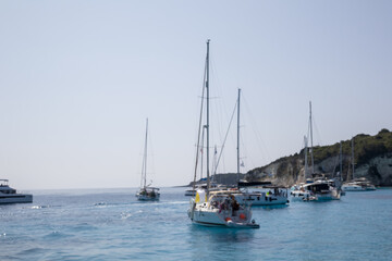 Fototapeta premium abstract blur sailboats on calm turquoise sea under clear sky