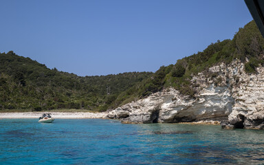idyllic greek island cove with turquoise water and white cliffs