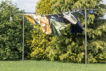 Fresh Clothes Drying on Line Among Greenery – Summer Household Chores