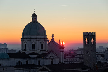 The Cathedral of Santa Maria Assunta and the Pegol Tower of Palazzo Broletto at sunset. Brescia, Lombardy, Italy.