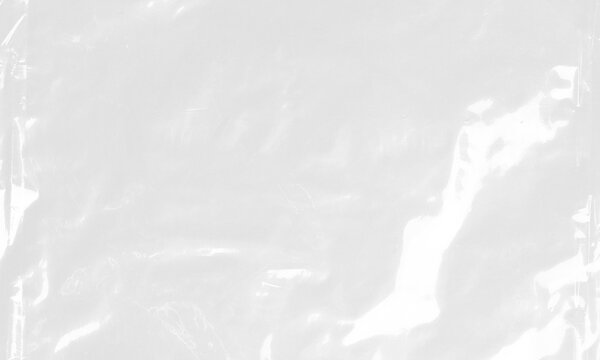 plastic transparent cellophane bag on white background. The texture looks blank and shiny. The plastic surface is wrinkly and tattered making abstract pattern