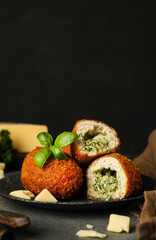 Chicken Kiev Cutlet with Herbs on Dark Background