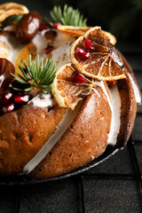 Macro of Christmas Cake with Icing, Dried Oranges, Dates, and Pomegranate Seeds