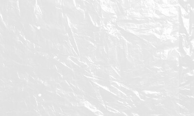 Naklejka premium plastic transparent cellophane bag on white background. The texture looks blank and shiny. The plastic surface is wrinkly and tattered making abstract pattern