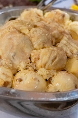 Delicious creamy ice cream served in a large bowl at a summer gathering in a cozy kitchen setting