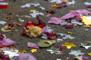 Colorful confetti and flower petals scattered on the ground after a joyful celebration in a vibrant community setting