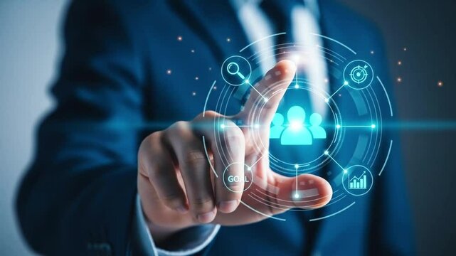 A businessmans hand interacts with a futuristic digital interface showing a team icon and various businessrelated symbols, representing strategic planning and goal achievement - Powered by Adobe