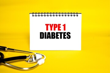 "TYPE 1 DIABETES" written on a white notepad with a bright yellow background, accompanied by a medical stethoscope.
