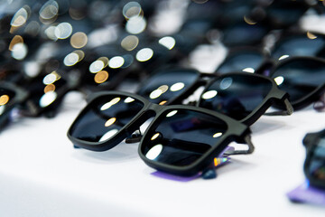 Many sunglasses are displayed in the store