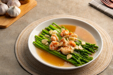 Asparagus with Shrimp and Garlic thick Sauce in white plate.