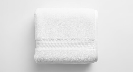 White folded towel product isolated on white background, featuring plush, fluffy, soft, dry and clean texture. Concept for baby care, spa treatments, hotel amenities, laundry products and hygiene.