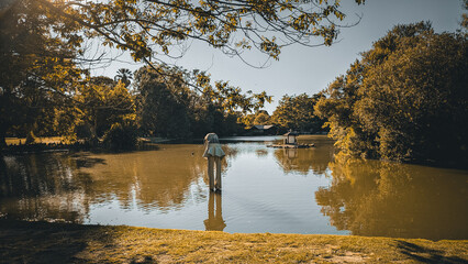 Solitary statue standing in the lake at Parc Borély, Borely Park, Marseille, Marseilles, France. Golden fine art light, peaceful, surreal, urban nature