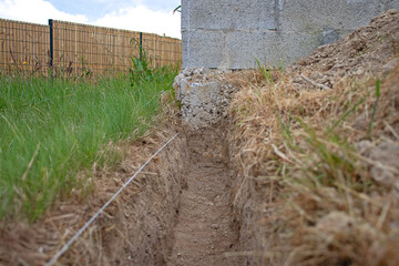  Digging a trench for fence  foundation. Earthwork