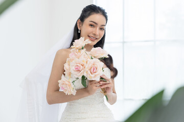 Bride wedding dress bouquet flowers white veil happiness beauty woman indoor. Bride elegant white...