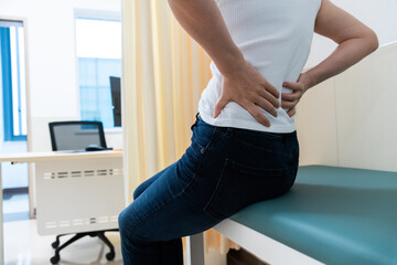 Woman with lower back pain in the doctor's office