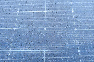 Close-up image of a grid-like solar panel with dark blue, black, and gray cells