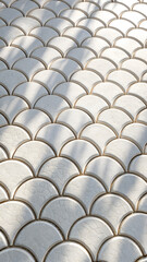 Fototapeta premium Stacked roof tiles on a building create a fascinating architectural pattern with unique texture and color variations