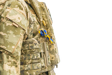 Person in olive-green camouflage uniform, with a bright blue and yellow object on left shoulder...