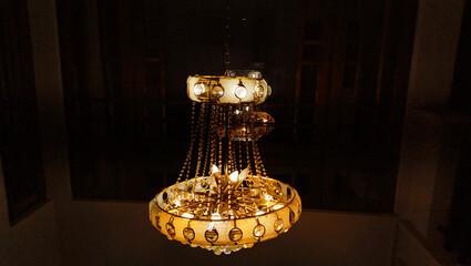 chandelier with black background hanging from cilling a very beautiful interior decoration item