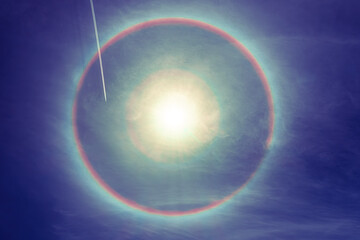a plane with a track through rare natural phenomenon created when sunlight hits ice crystals suspended high in the atmosphere