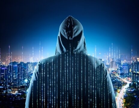 anonymous hacker observing cityscape at night with binary code on hoodie - Powered by Adobe