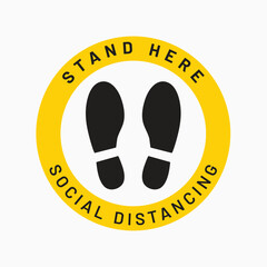 Social Distancing Reminder: A close-up view of a social distancing floor sticker. this visual element is a circular sign with bold text and footprint symbols.